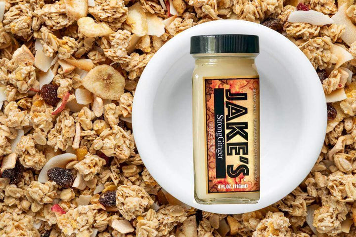 A 4oz bottle of Jake's StrongGinger organic ginger juice on a bowl of cereal 
