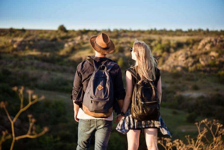 A couple on the edge of a canyon enjoying a glass of Jake's StrongGinger organic ginger juice
