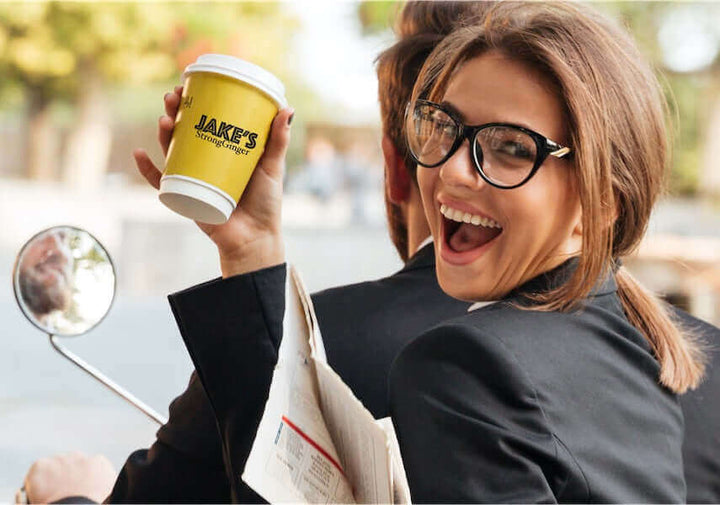 Jake's StrongGinger organic ginger juice being enjoyed by a professional woman on the go