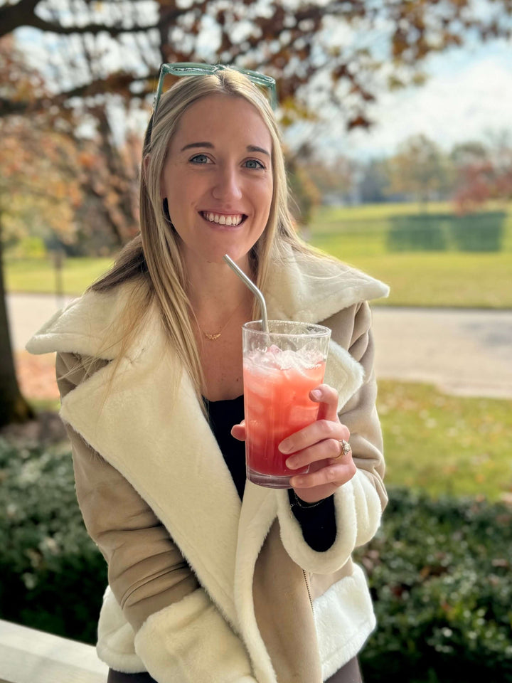Christiana drinking a Jake’s mocktail made with Jake's StrongGinger organic ginger juice