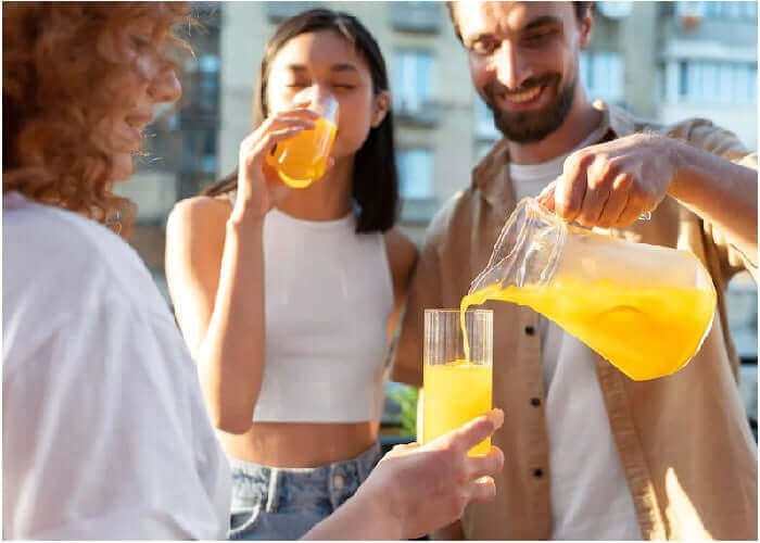 Jake's StrongGinger organic ginger juice mixed with pineapple juice enjoyed by 2 couples.