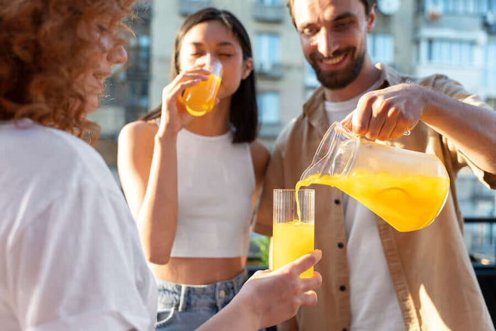 Jake's StrongGinger organic ginger juice being poured in a glass for cocktails among couples.