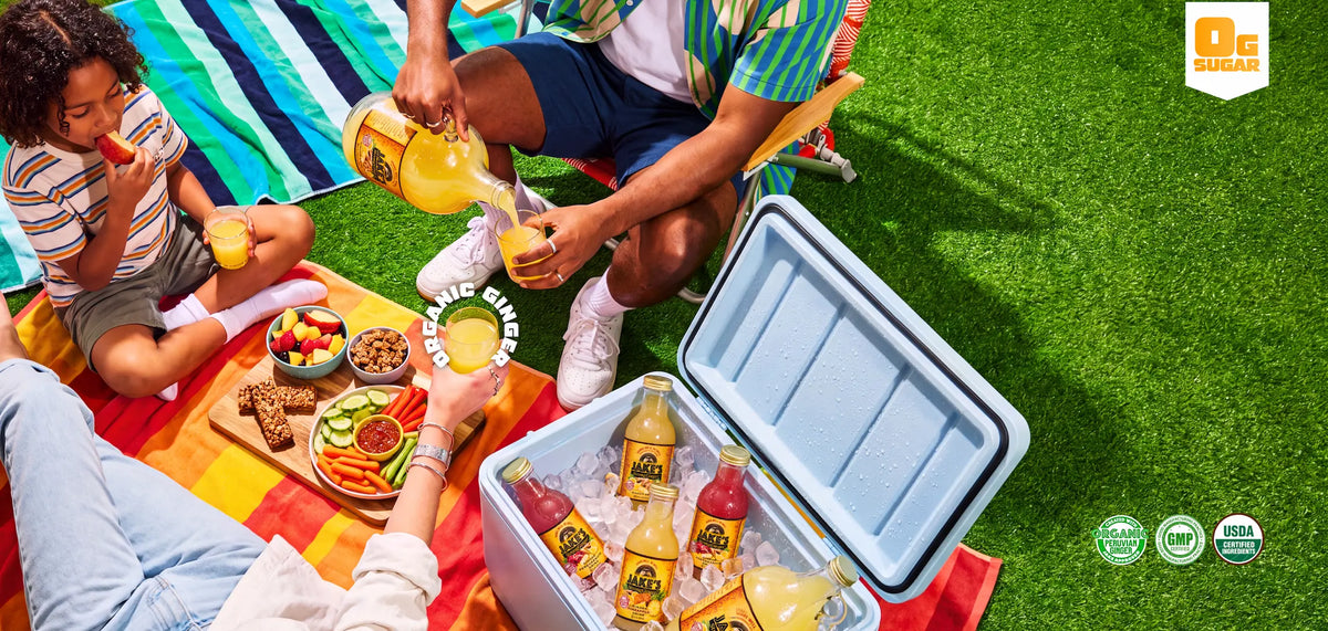 People share Jake’s StrongGinger drinks at a picnic beside an open cooler.